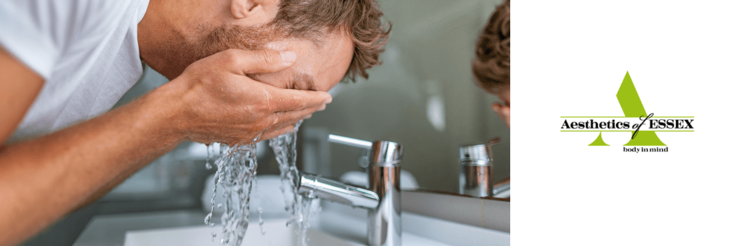 man washing his face to treat acne