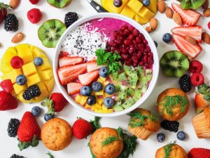 Vibrant pink smoothie bowl with fresh fruit for healthy skin